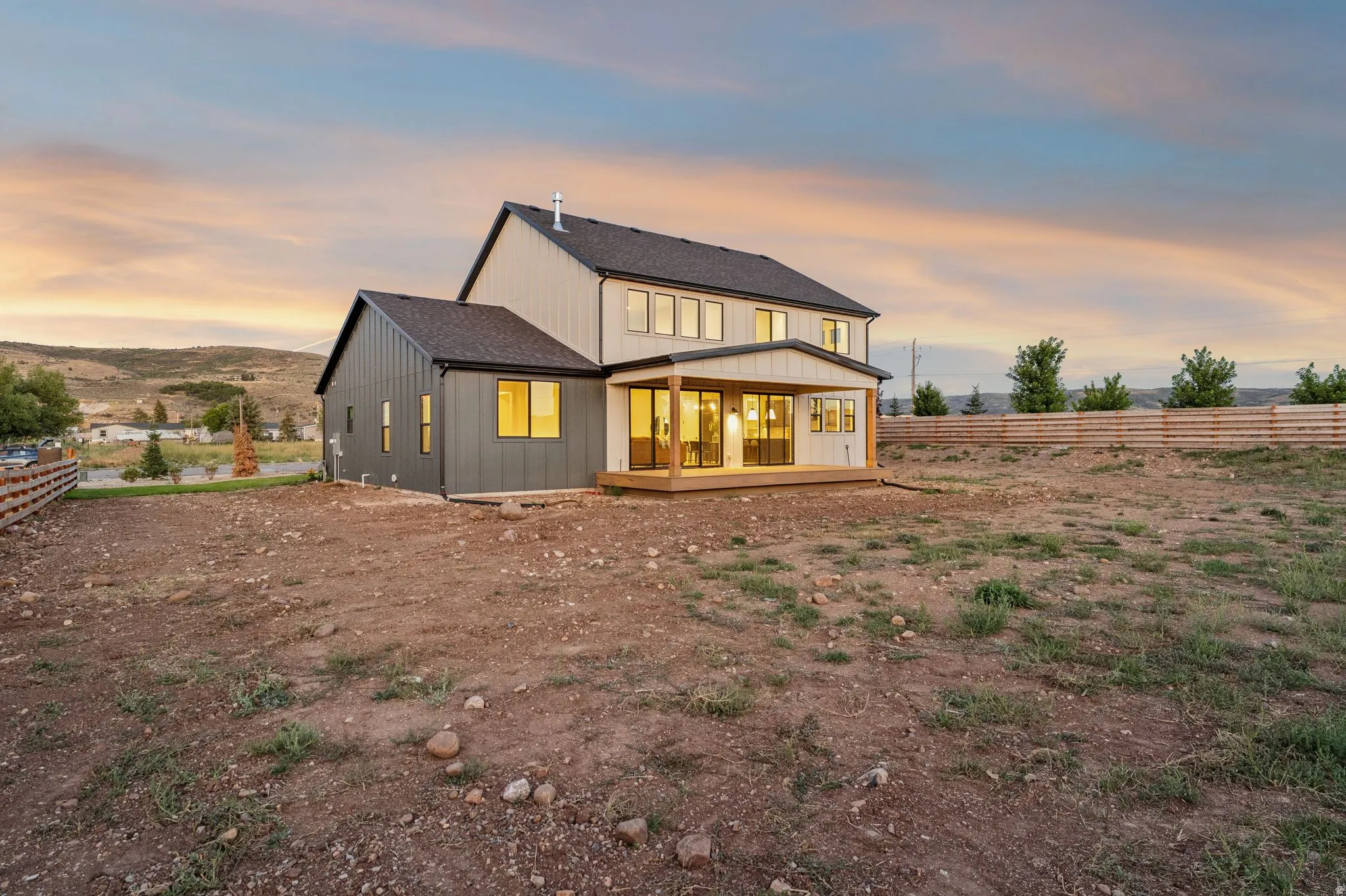 Two-story residence with a covered patio and multi-panel sliding glass doors