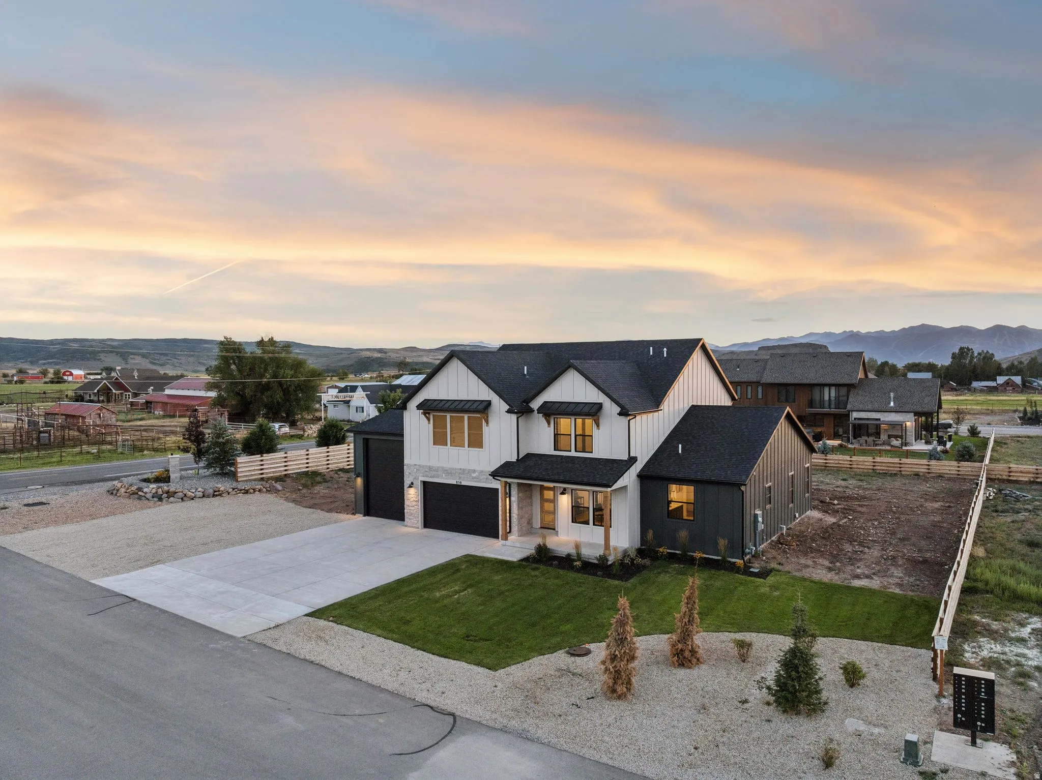 Modern farmhouse exterior with dark siding and white vertical siding