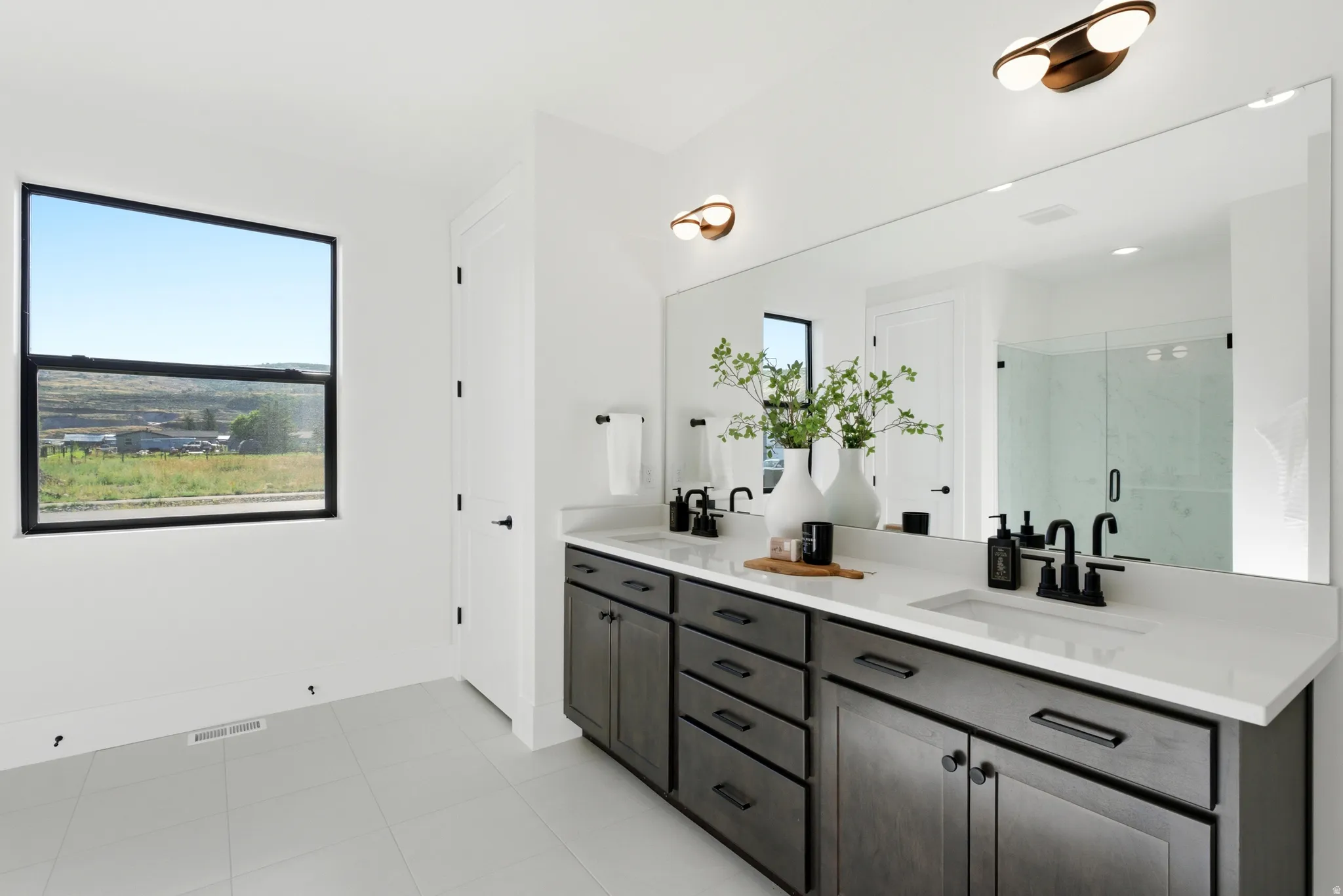 Dual vanity with integrated sinks, white countertop, and dark wood-finish cabinetry