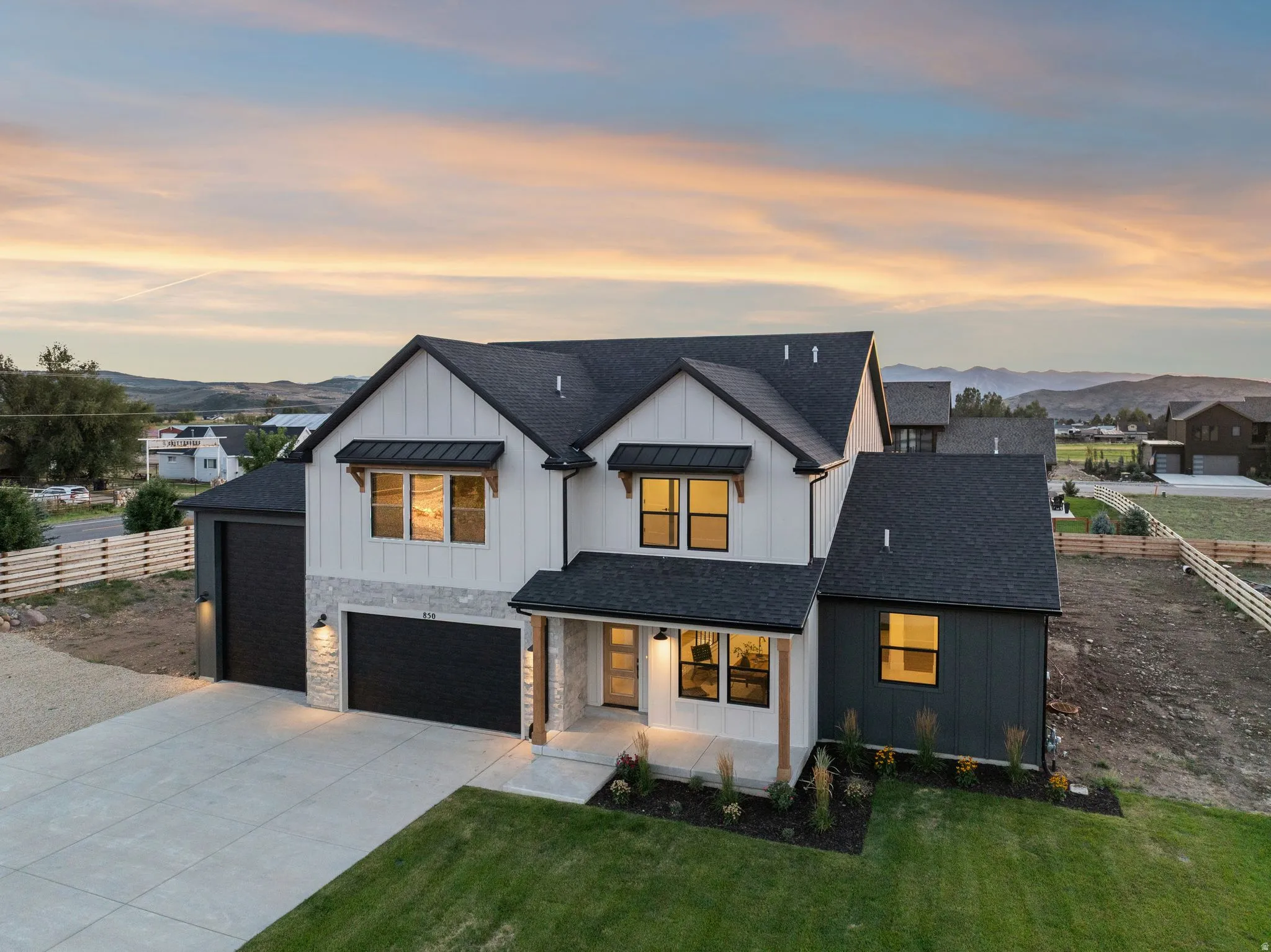 Modern farmhouse-style residence with dark asphalt shingle roof