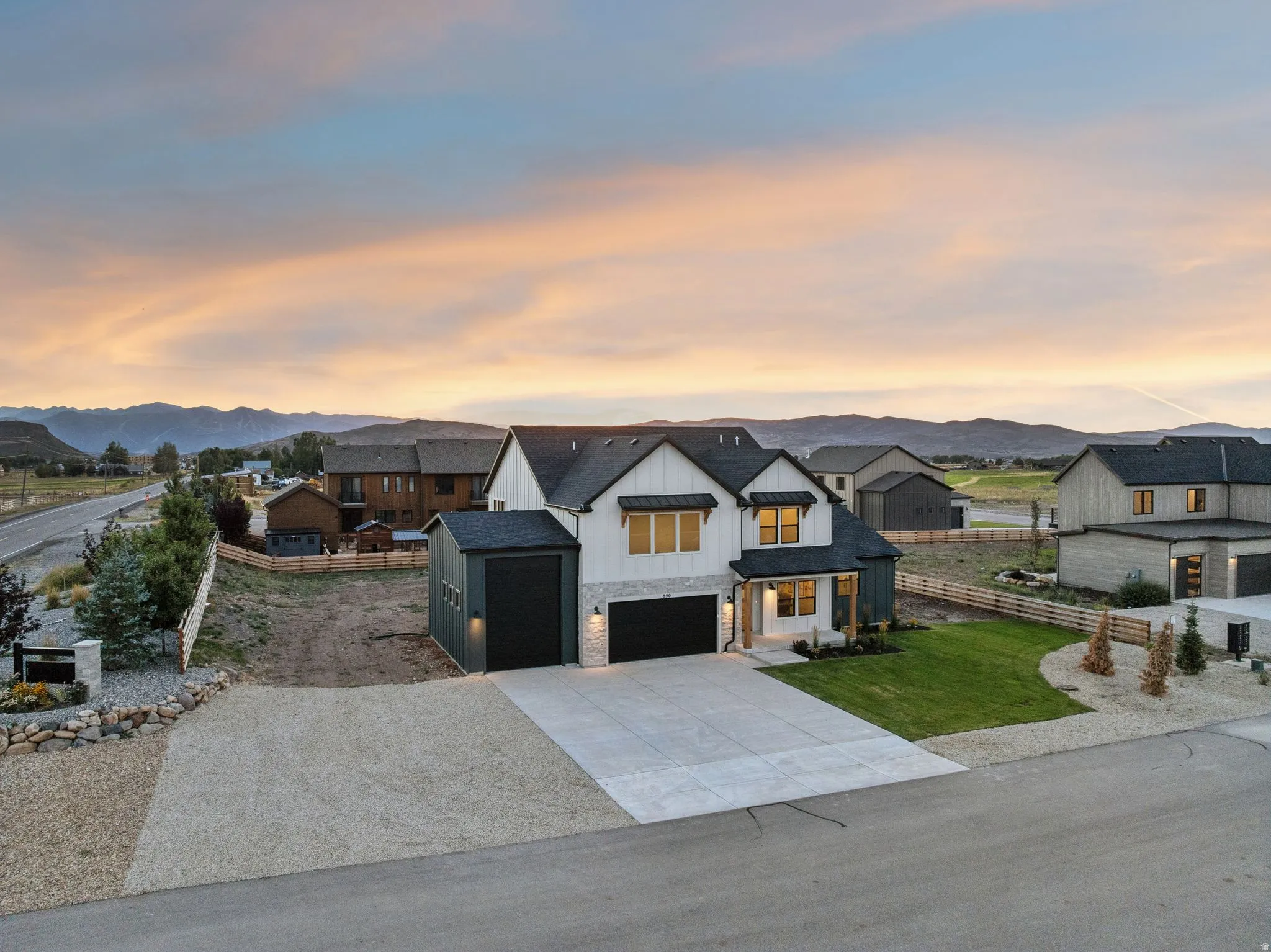 Modern architectural design with a dark gable roof and white siding accents