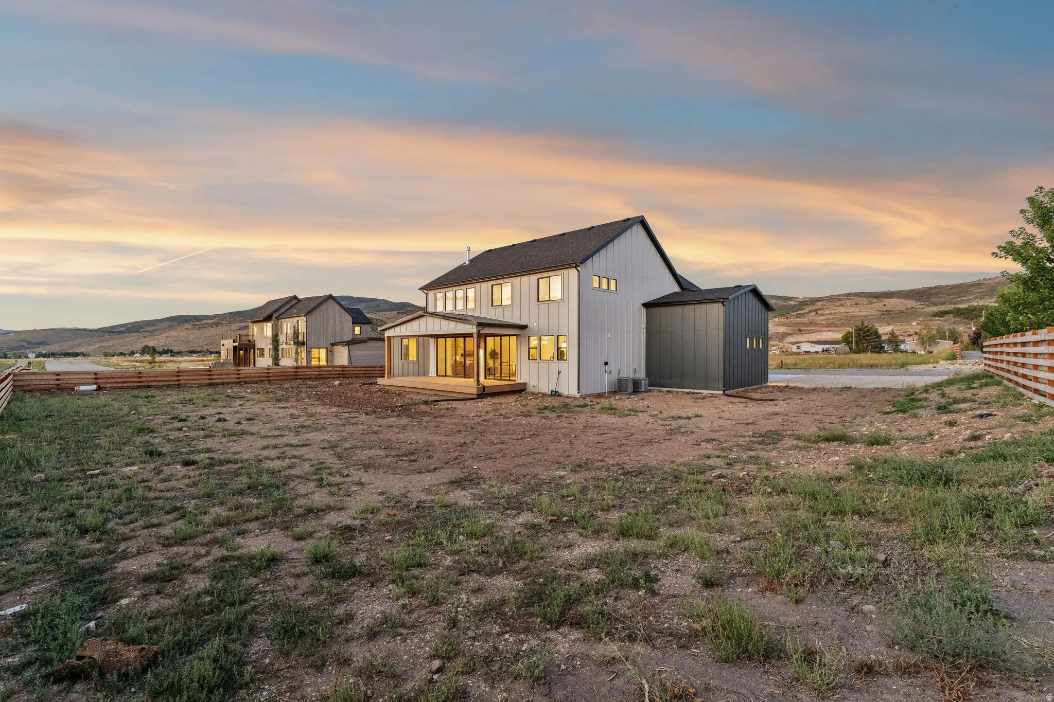 Contemporary architectural design with a dark gray roof and light gray siding
