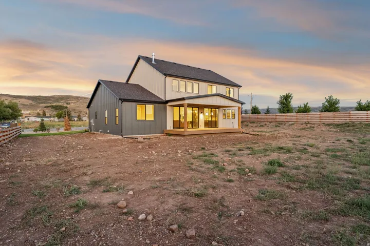 Two-story residence with a covered patio and multi-panel sliding glass doors