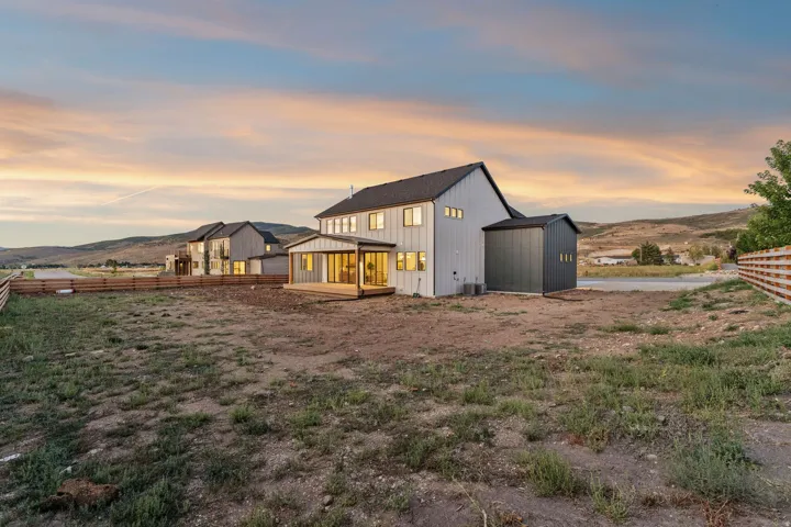 Contemporary architectural design with a dark gray roof and light gray siding