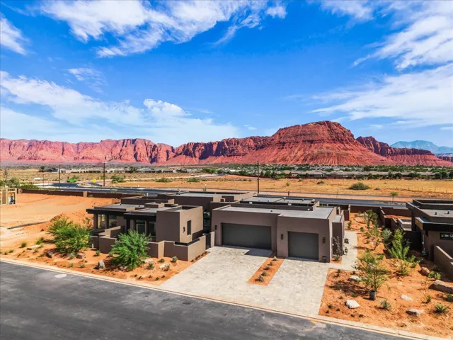 Modern exterior architecture with a flat roofline, neutral stucco finish, and an attached two-car garage