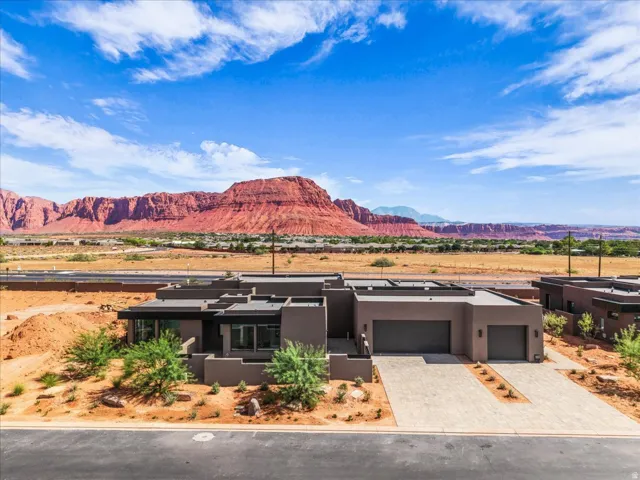 Contemporary exterior with flat roofline, integrated two-car garage, and desert landscaping