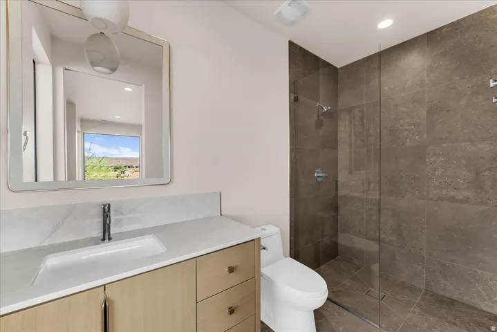 Floating wood-finish vanity with an integrated sink and rectangular mirror