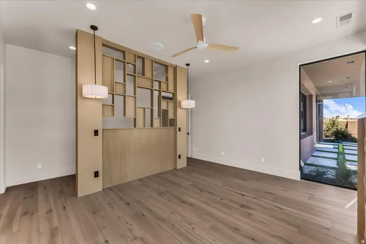 Wood-finish flooring, recessed lighting, and a contemporary ceiling fan