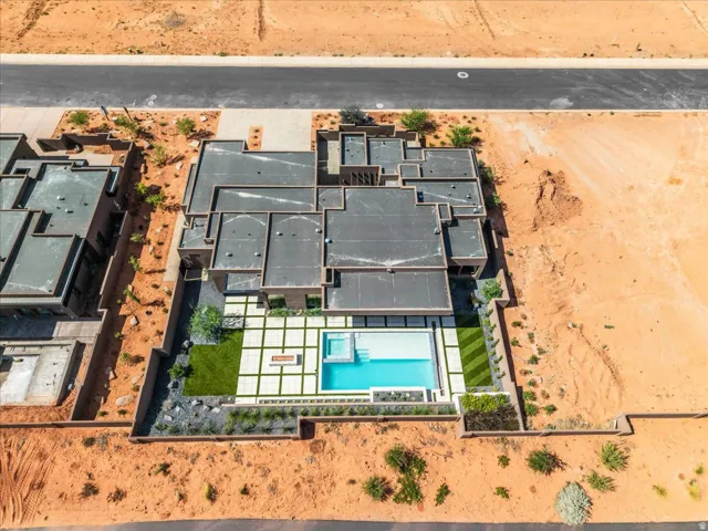 Modern residence featuring a flat roofline, geometric paving, a rectangular swimming pool, and an integrated spa