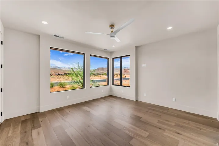 Hardwood flooring, recessed lighting, and a modern ceiling fan