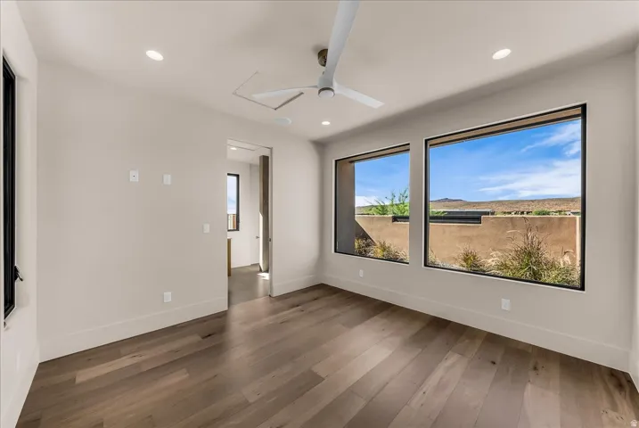 Room featuring wood-finish flooring, recessed lighting, and a contemporary ceiling fan