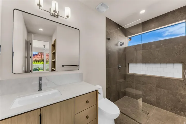 Floating vanity with integrated rectangular sink and waterfall edge countertop