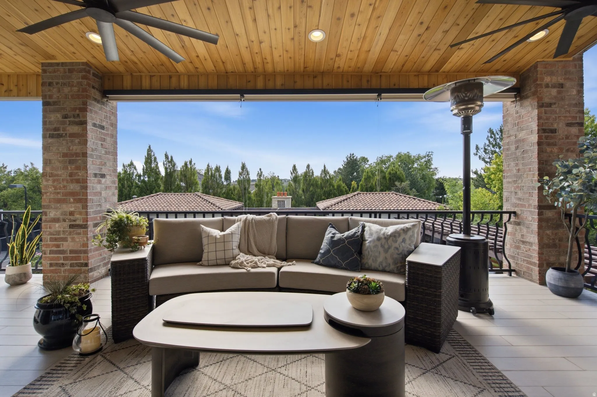 Covered patio with a wood-plank ceiling, recessed lighting, and ceiling fans