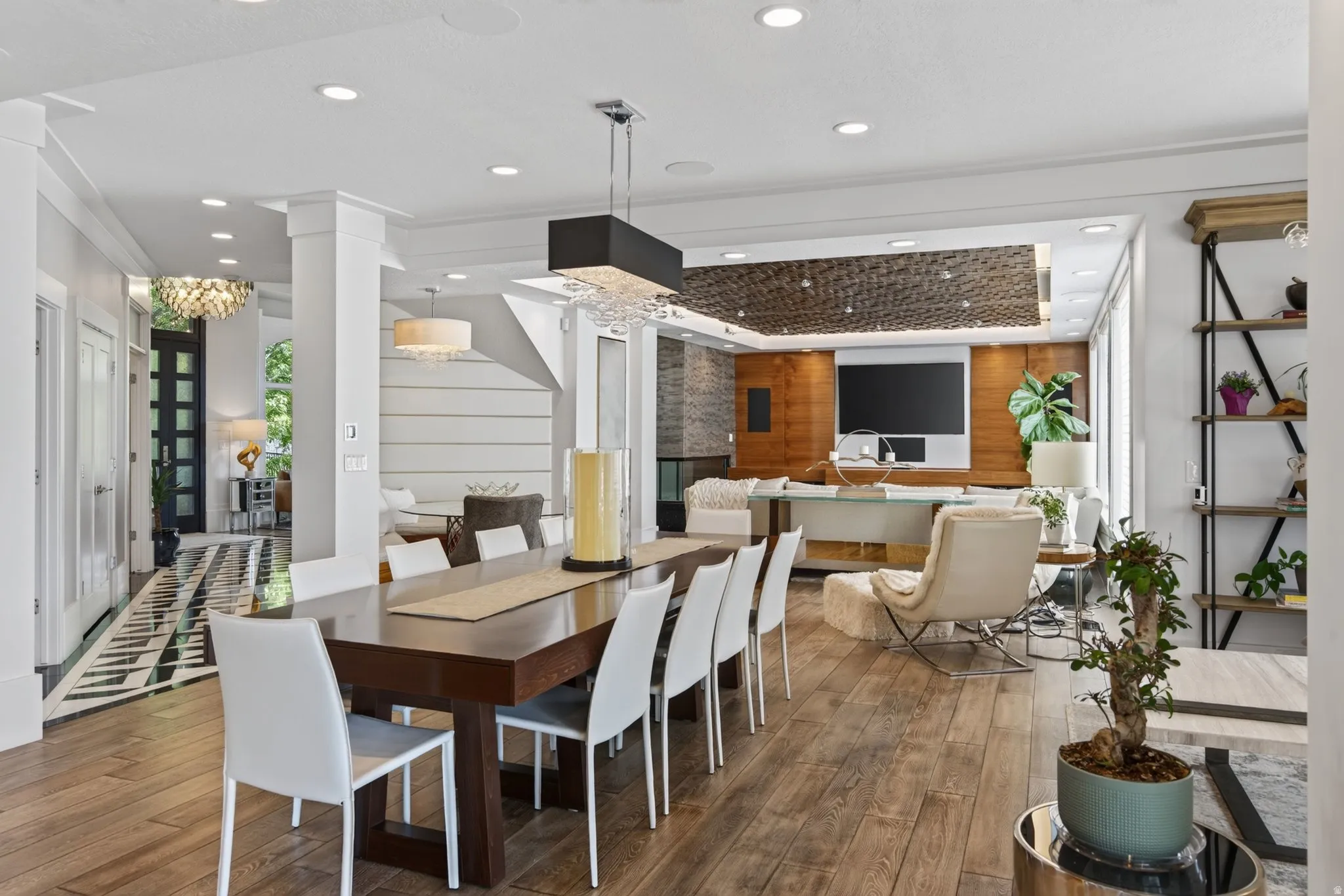 Wood-finish flooring throughout, integrated recessed lighting, and a contemporary linear chandelier
