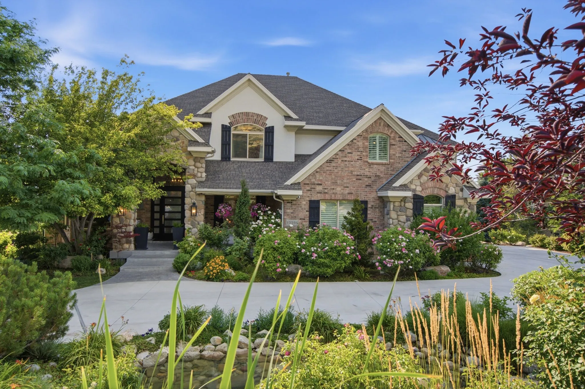 Stone and brick exterior with a multi-gabled roofline