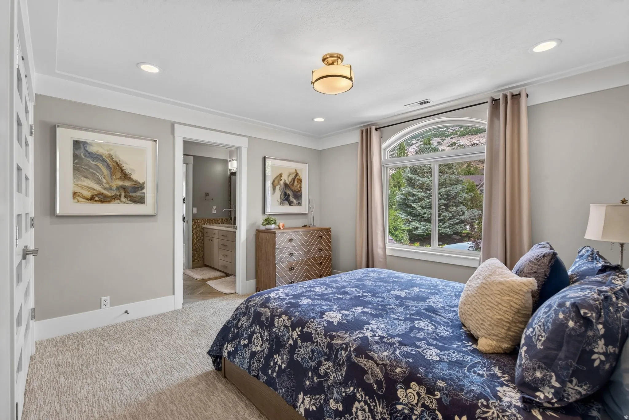 Recessed lighting, arched window, crown molding, paneled door, and ceiling light fixture
