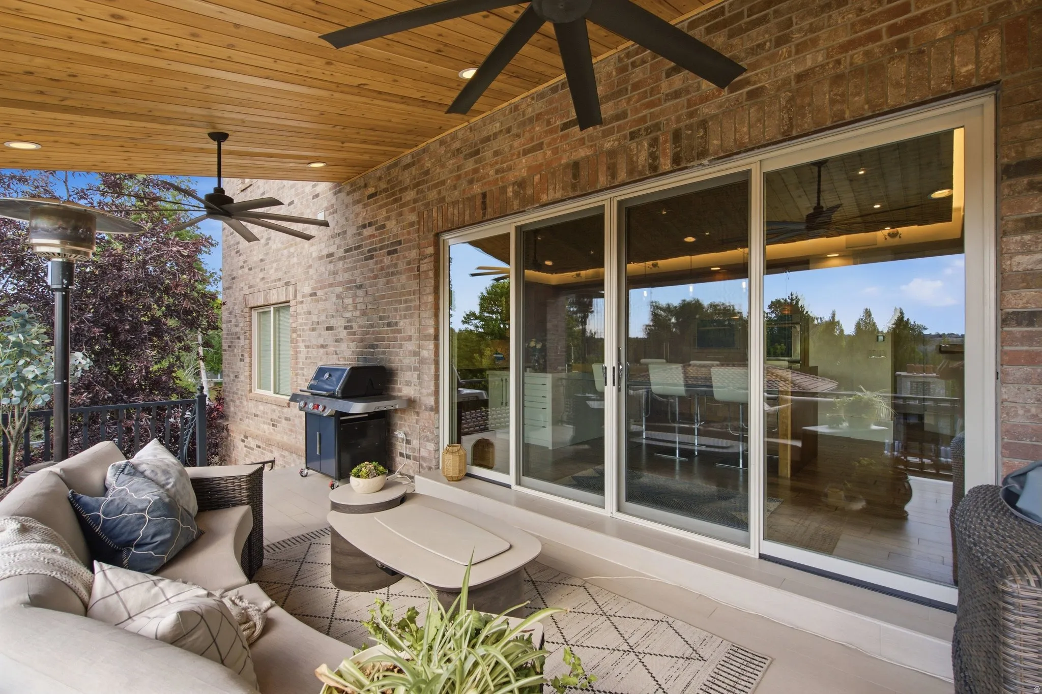 Covered patio with a wood-finish ceiling, recessed lighting, and ceiling fans