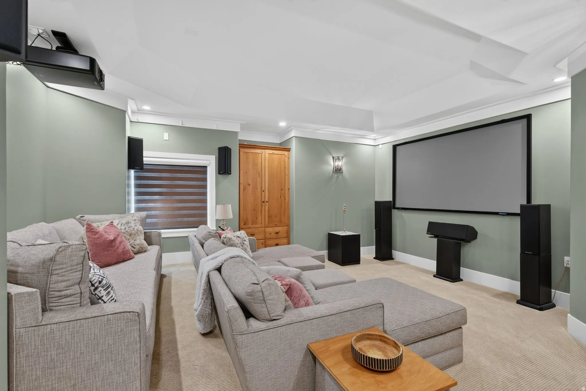 Theater room featuring a large projection screen, recessed lighting, and crown molding