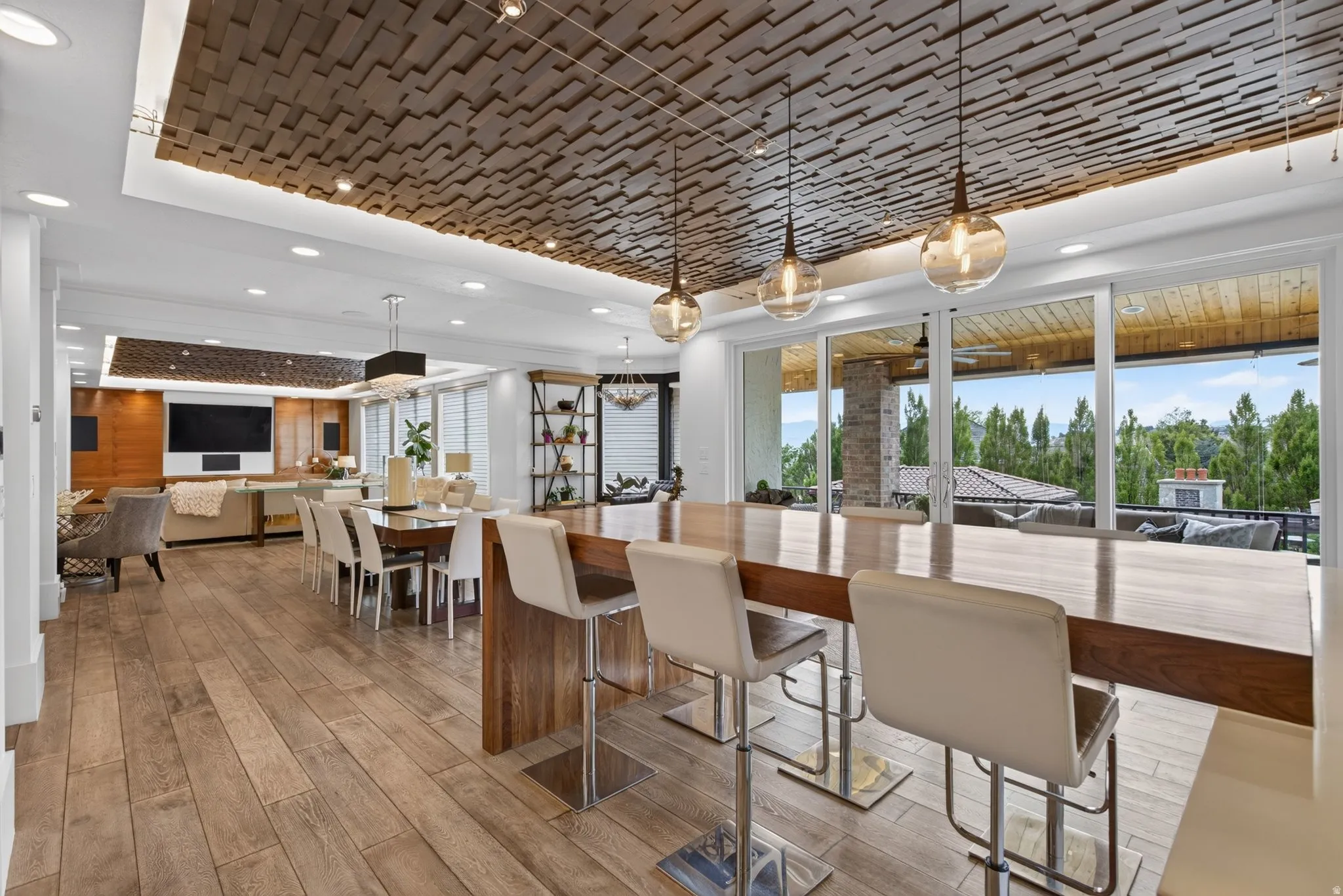 Wood-finish flooring throughout, with a wood panel ceiling feature and recessed lighting
