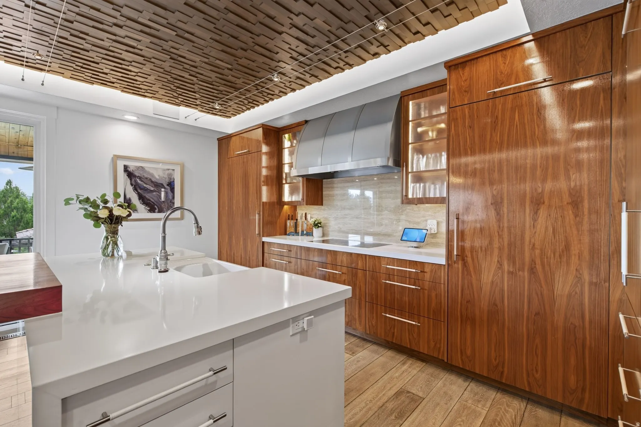 White kitchen island with an integrated sink and gooseneck faucet