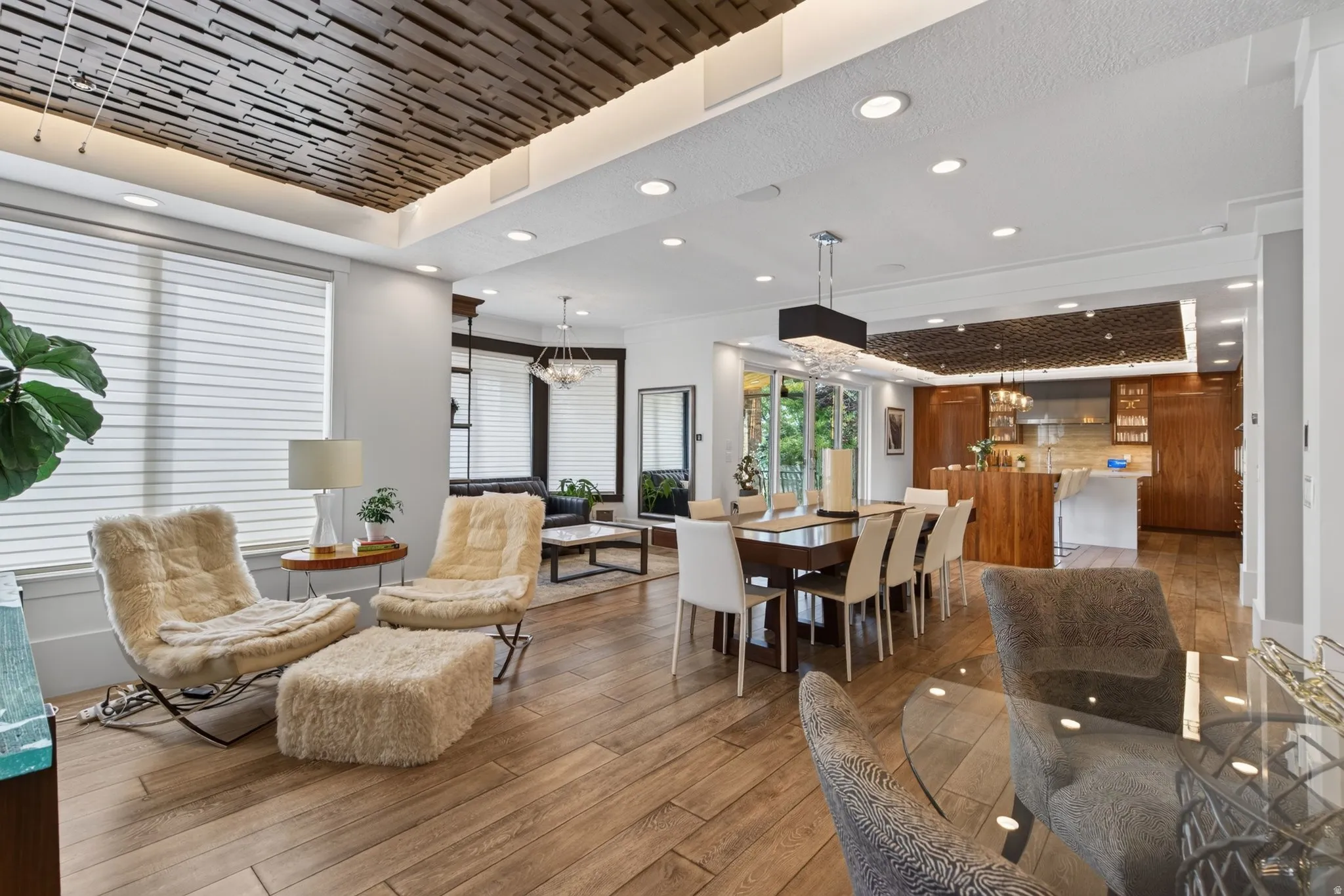 Wood-finish flooring throughout, recessed lighting, and a decorative ceiling panel with integrated lighting
