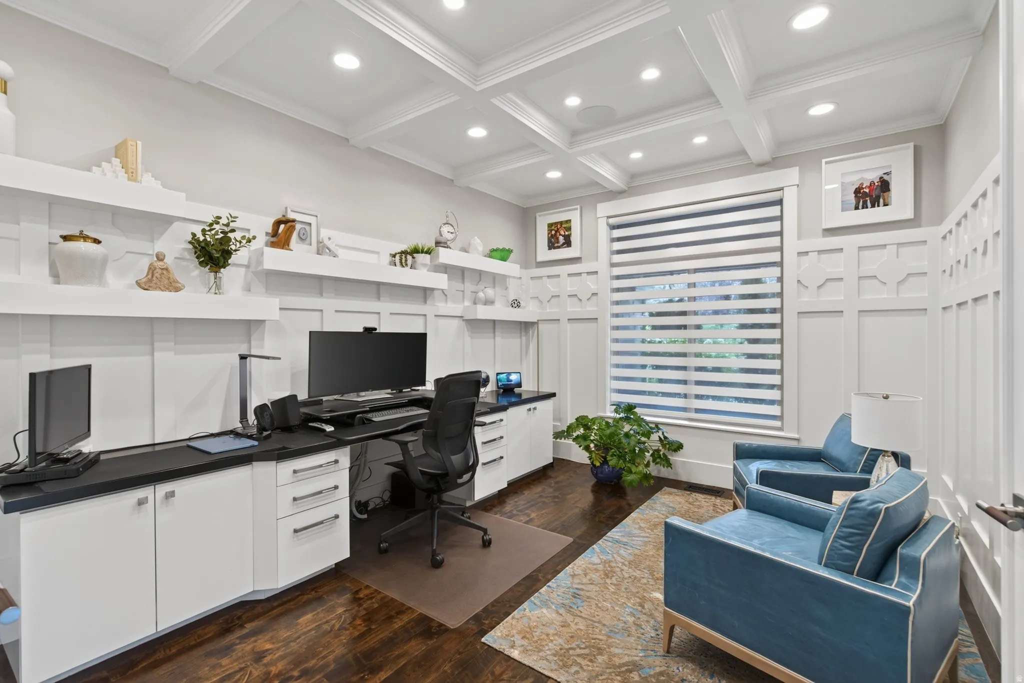 Coffered ceiling, dark wood-finish flooring, built-in white cabinetry, integrated desk space, and a window with blinds