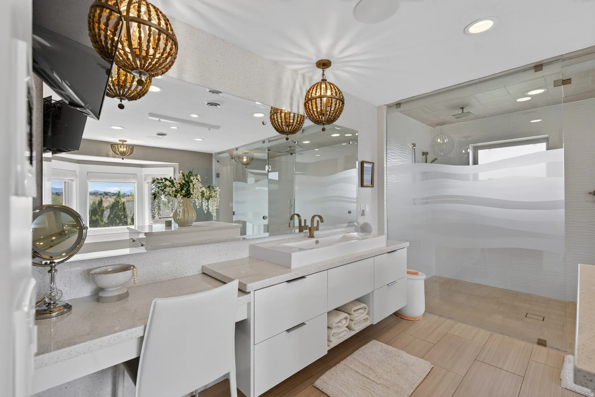 Modern vanity with dual vessel sinks, glass-enclosed shower, and recessed lighting