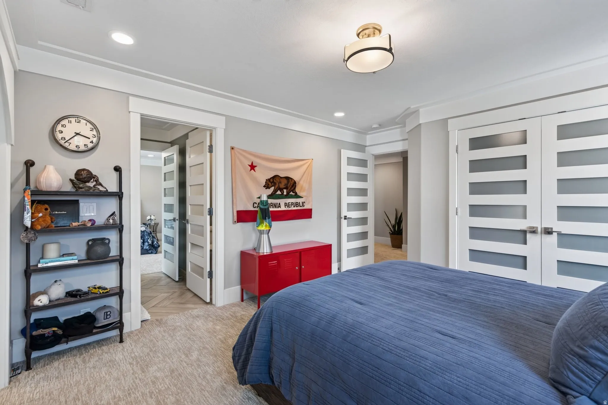 Recessed lighting, crown molding, modern semi-flush mount light fixture, white interior doors with frosted glass panels, and light-toned carpeting