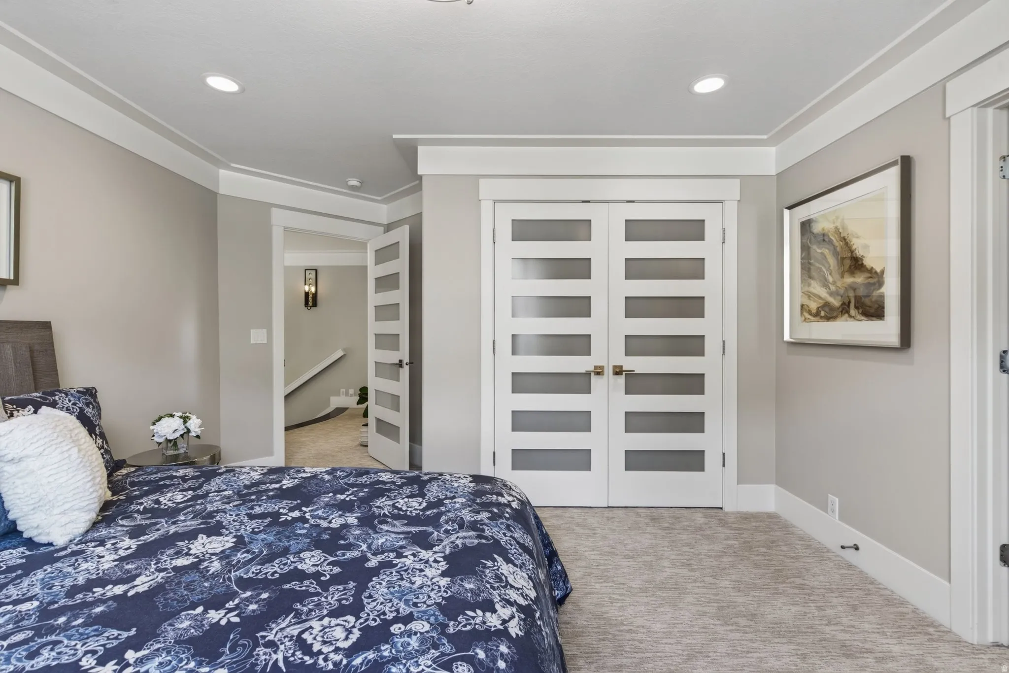 Recessed lighting, crown molding, white trim work, light gray wall tones, and carpeted flooring