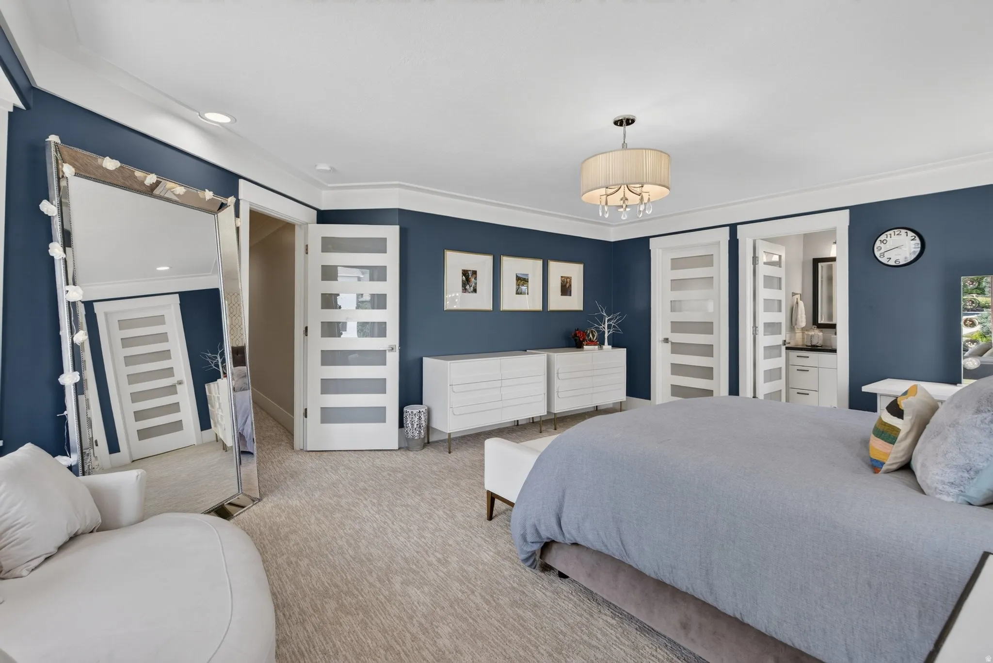 Recessed lighting, crown molding, drum chandelier, and two frosted panel doors