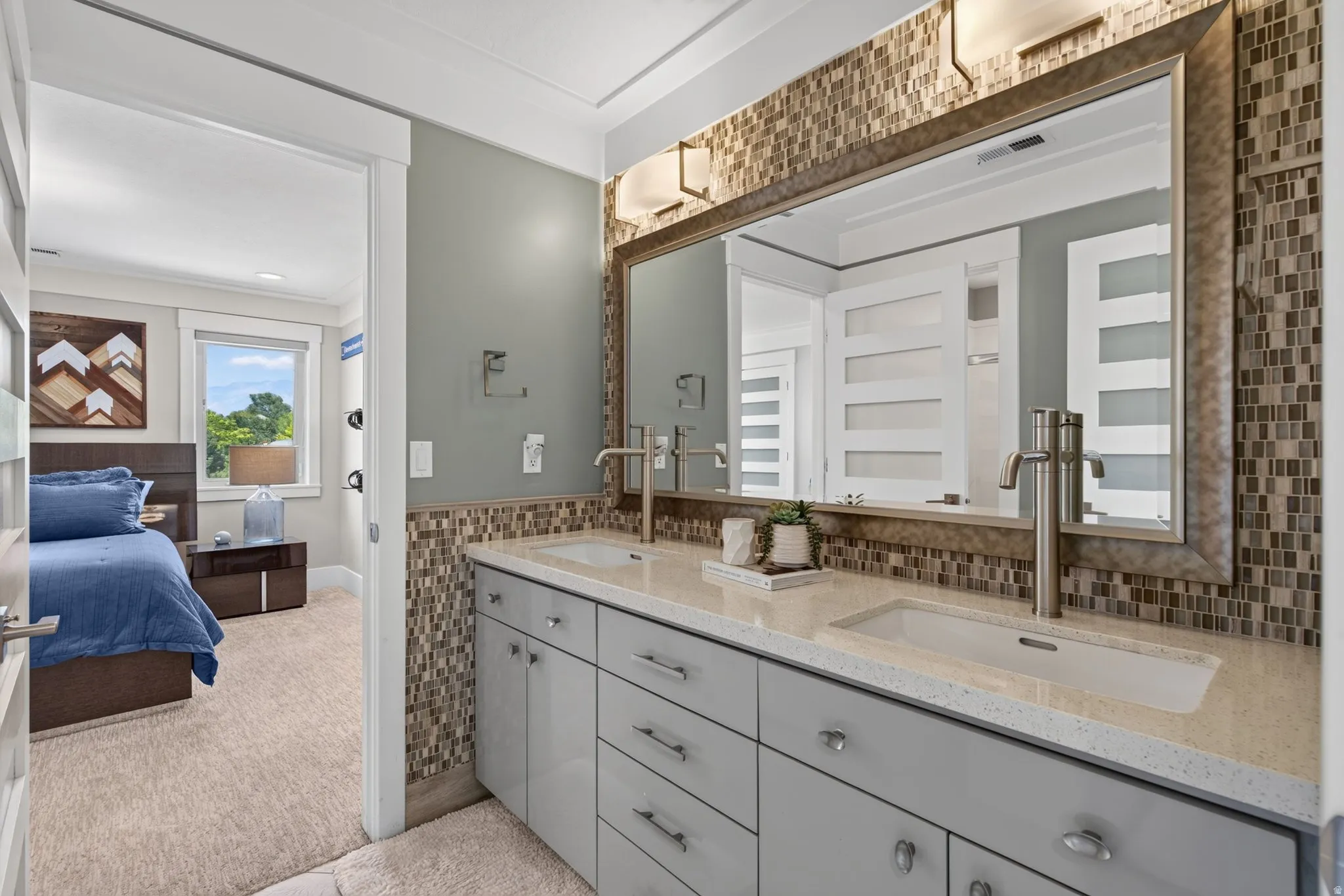 Double vanity with light gray cabinetry, integrated rectangular sinks, and a mosaic tile backsplash