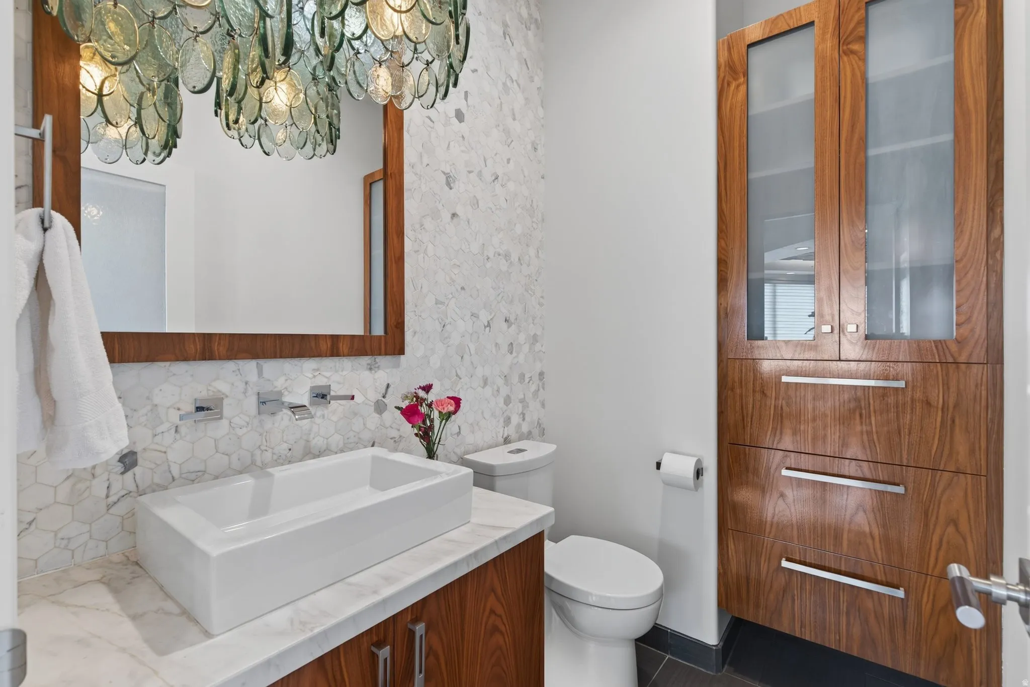 Rectangular vessel sink with wall-mounted chrome fixtures
