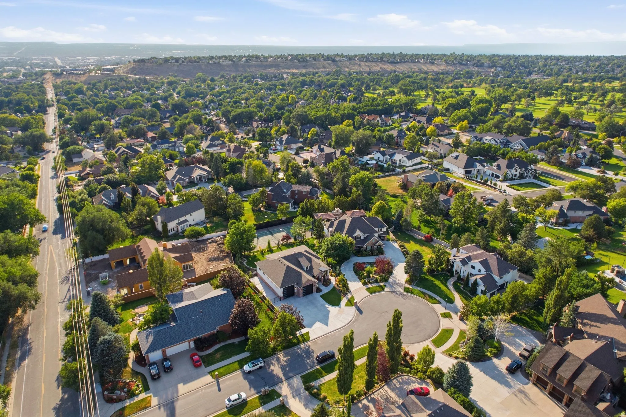 Expansive residential area featuring established homes, mature trees, and a golf course