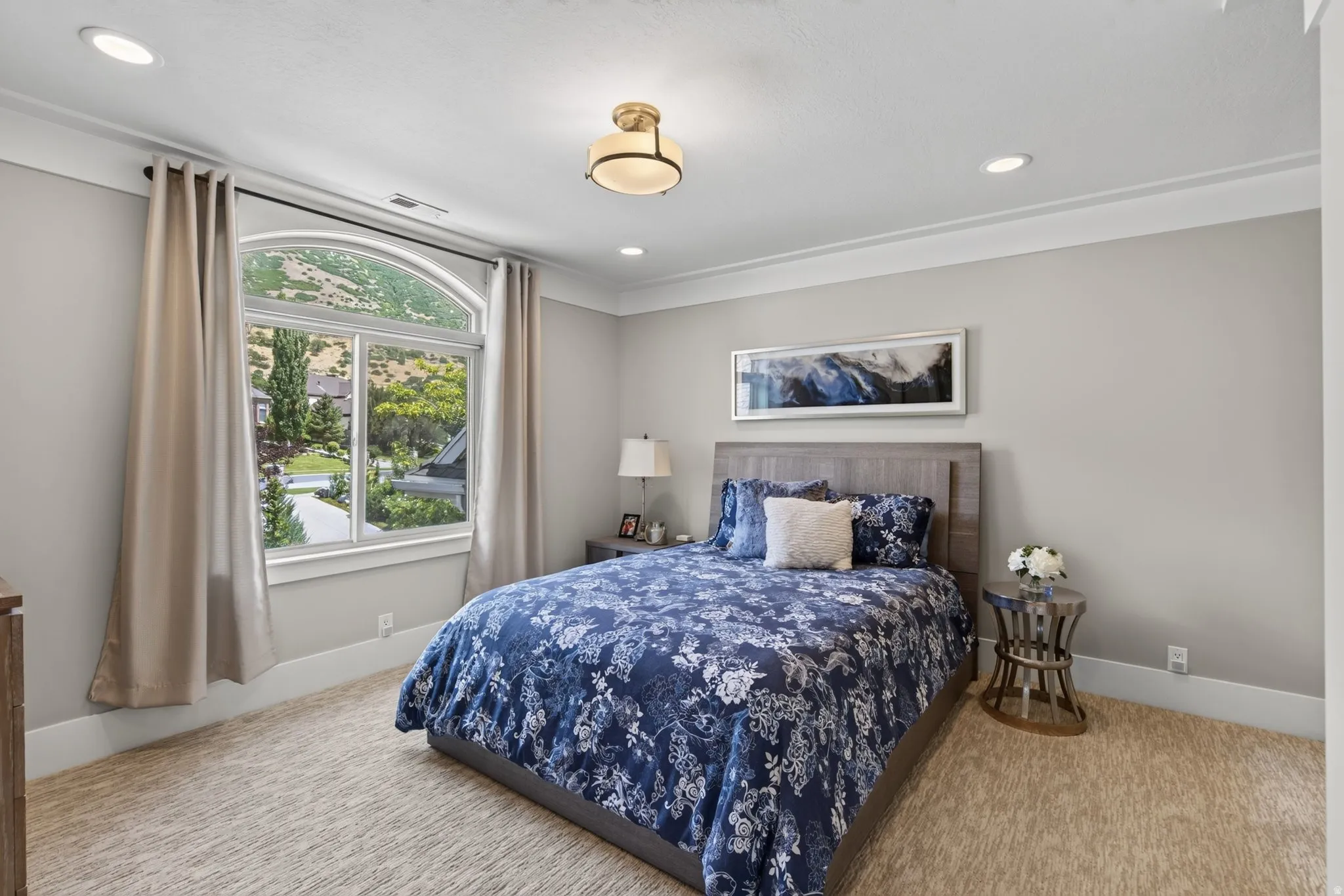 Arch-top window with exterior scenery, crown molding, recessed lighting, and a semi-flush ceiling fixture
