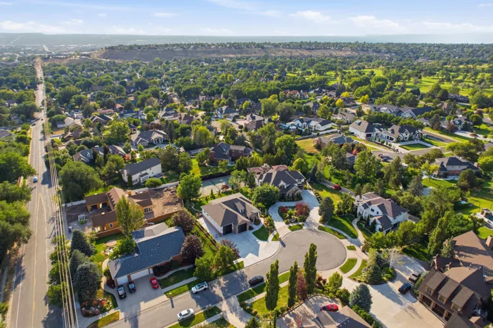 Expansive residential area featuring established homes, mature trees, and a golf course