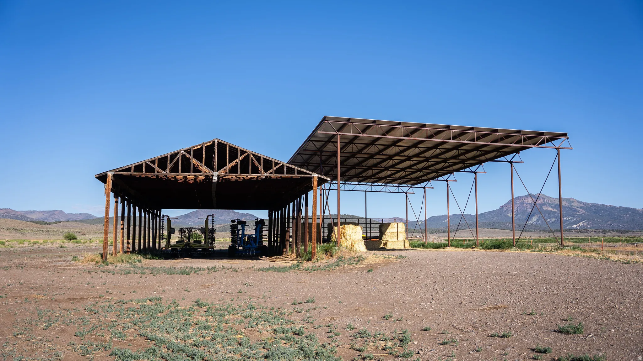 Expansive open-air structures with metal framing and corrugated metal roofing