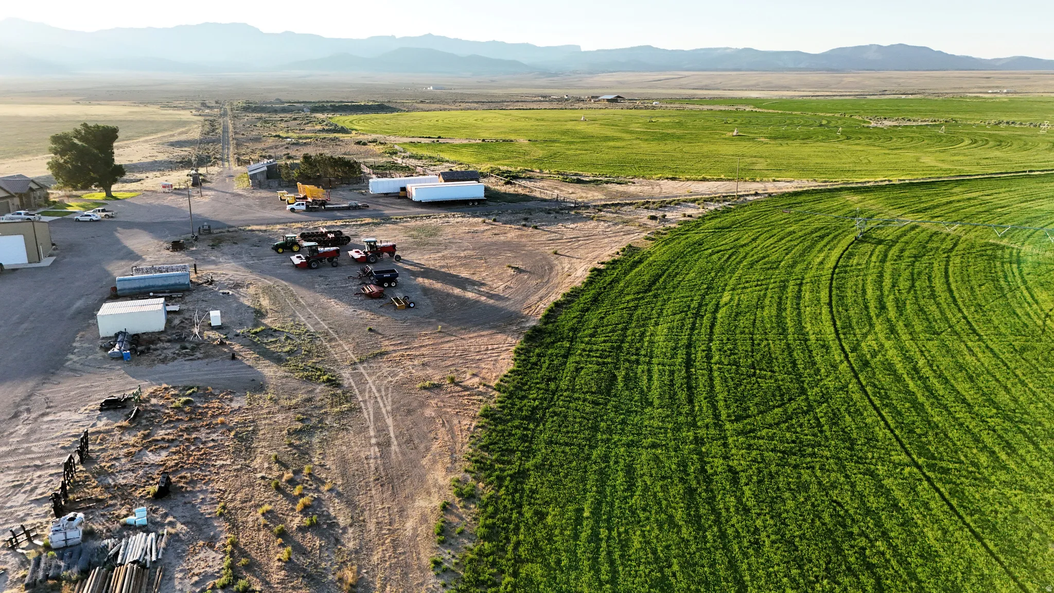 Expansive agricultural land featuring a circular green field and additional open fields
