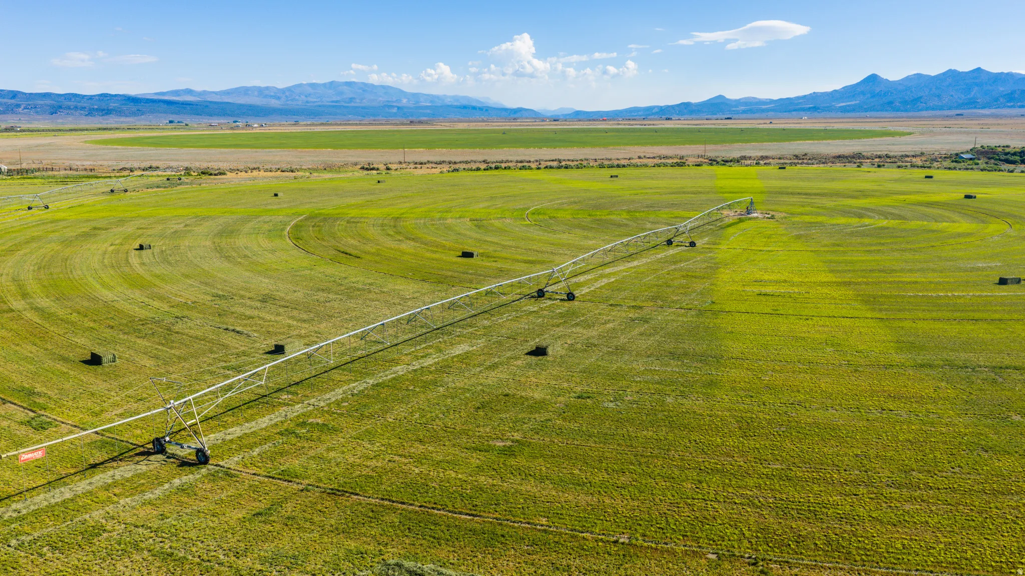 Expansive agricultural land featuring a center pivot irrigation system