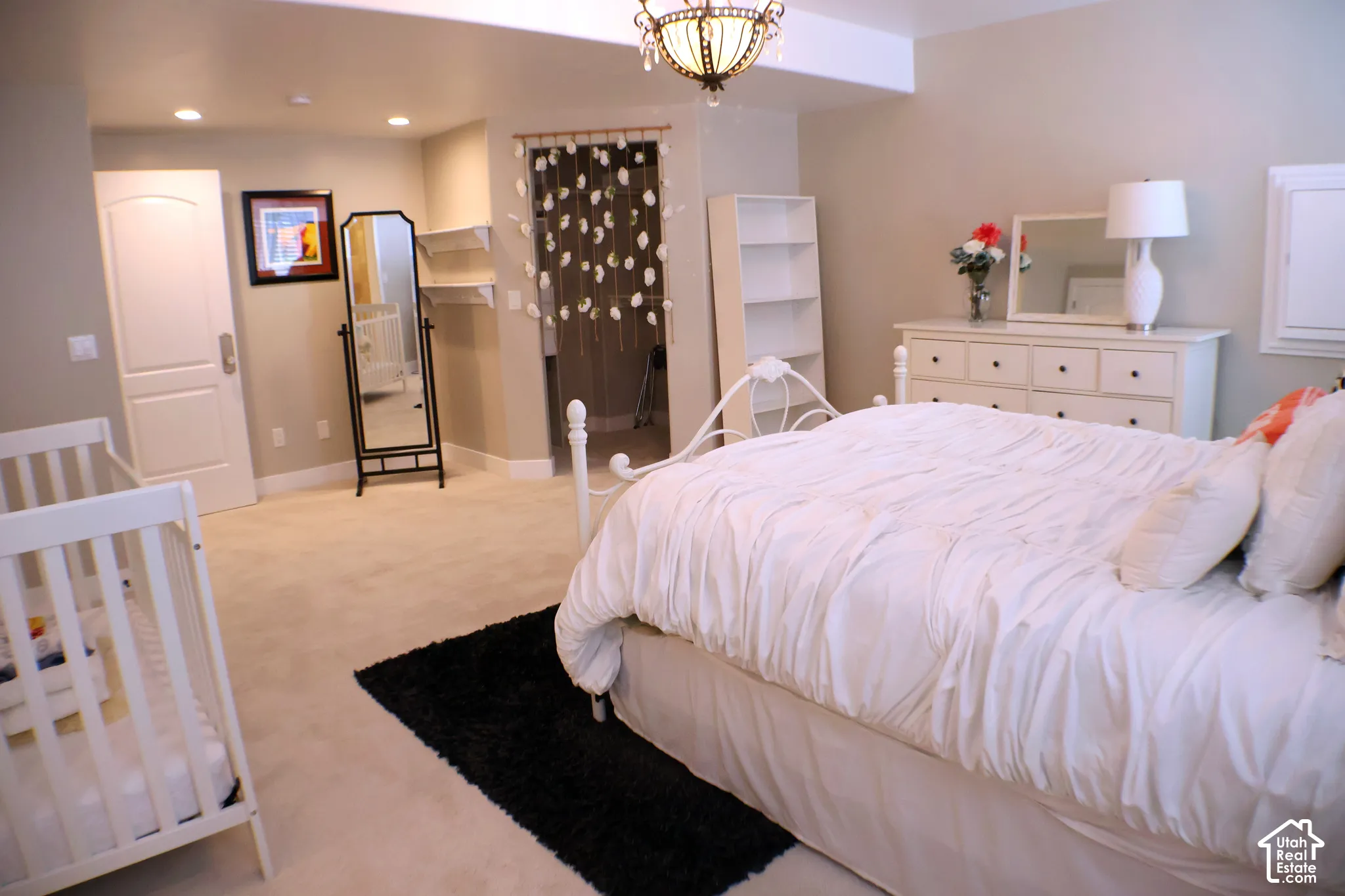 Recessed lighting illuminates neutral-toned walls and plush carpeting