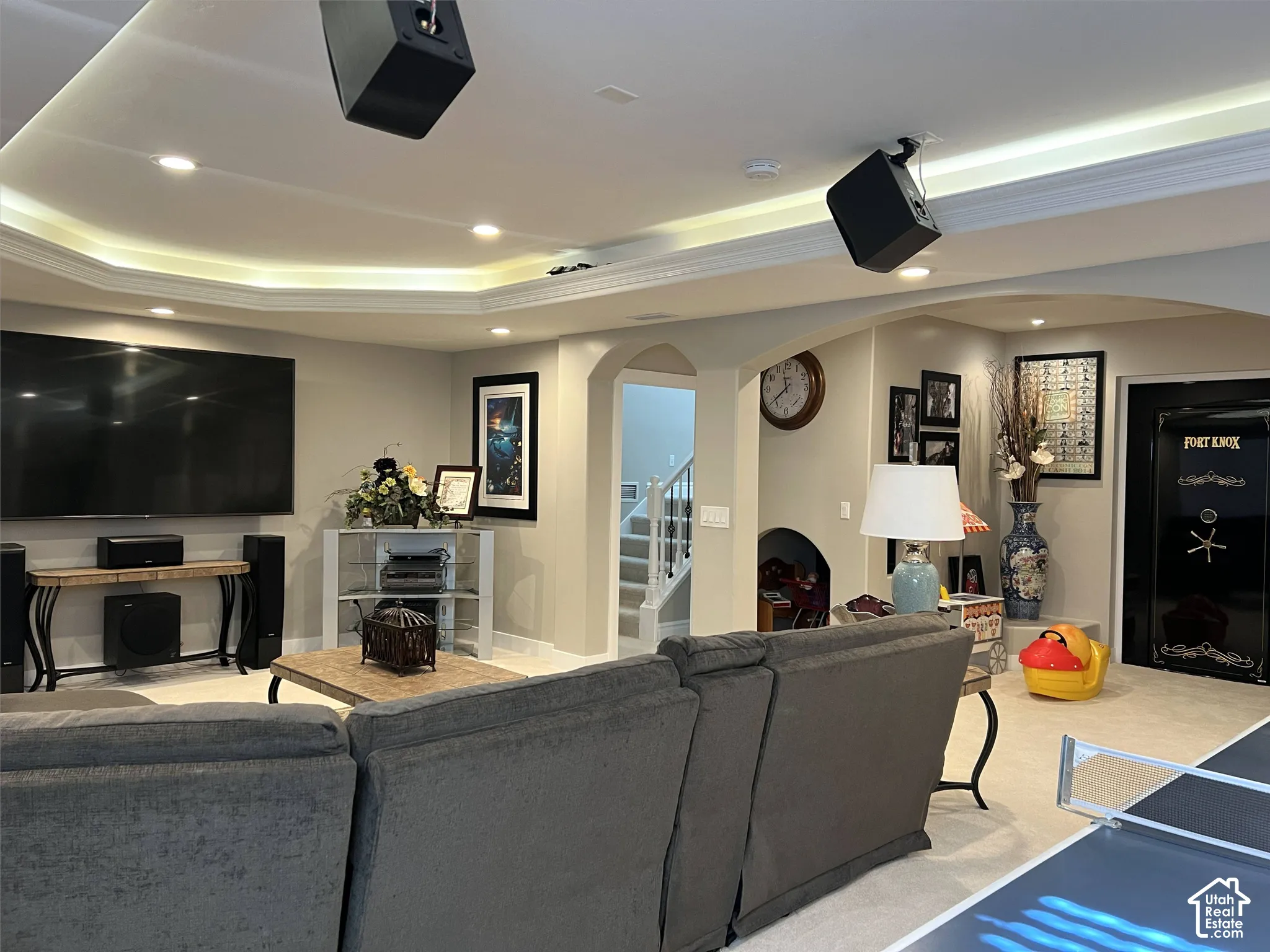 Recessed lighting, cove lighting, painted walls, carpeted flooring, arched doorways