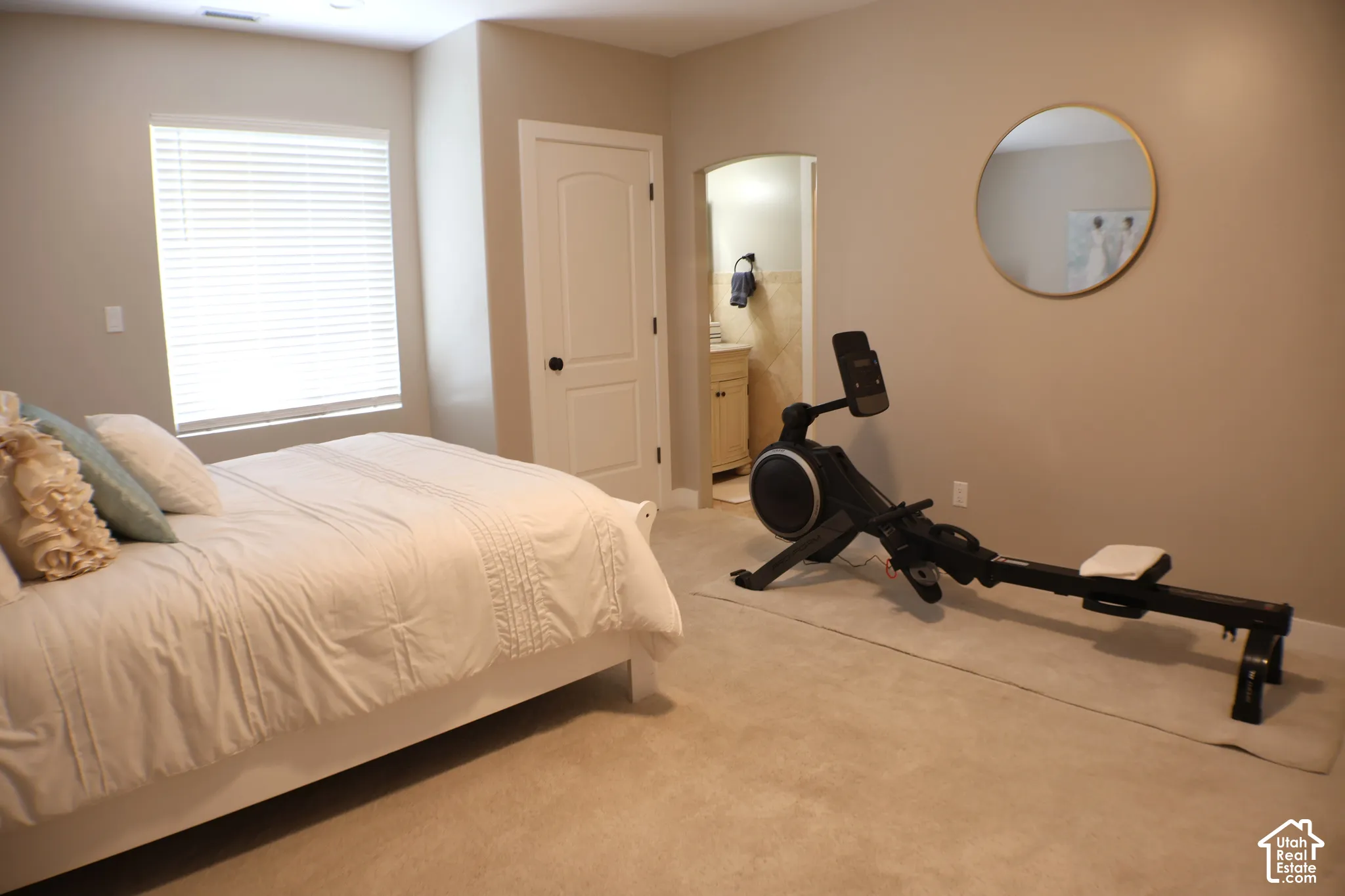 Carpeted flooring, arched doorway, and built-in vanity