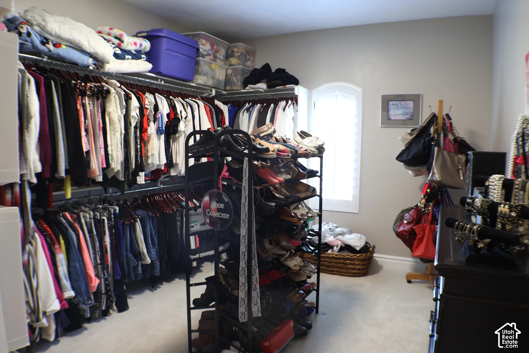 Built-in closet organization system with multiple hanging rods and shelving