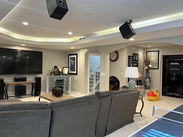 Recessed lighting, cove lighting, painted walls, carpeted flooring, arched doorways