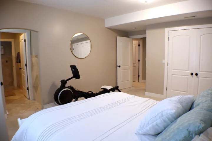 Neutral-toned walls, white trim, recessed ceiling lighting, arched doorways, and built-in double closet doors