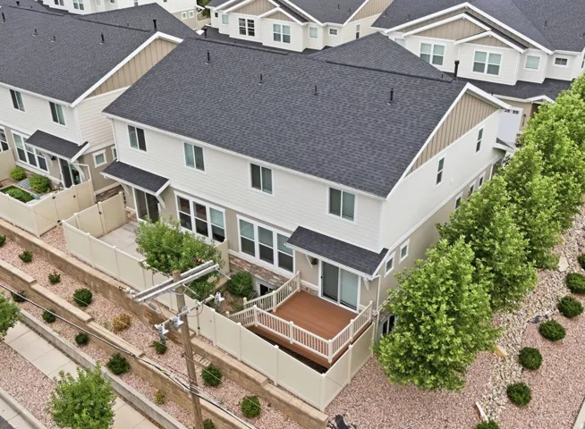 Multi-level exterior with light siding and dark shingle roofing