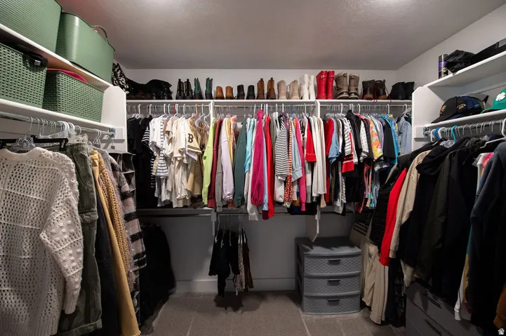 Built-in closet organization system with multiple shelving units and hanging rods, providing extensive storage options