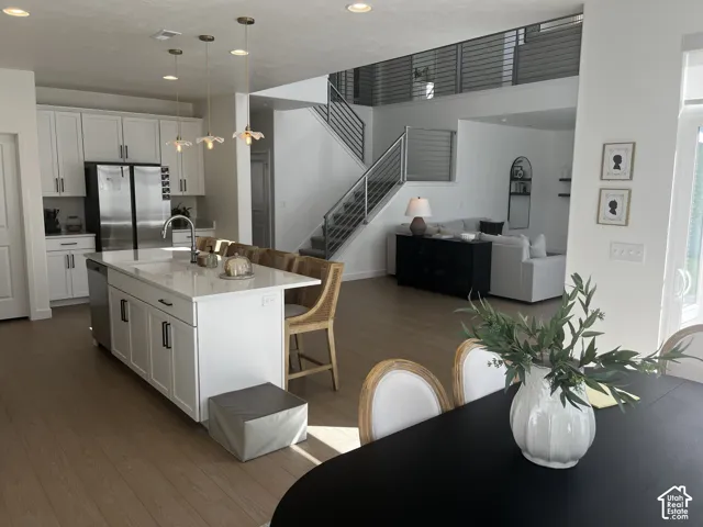 Open-concept living space with wood-finish flooring
