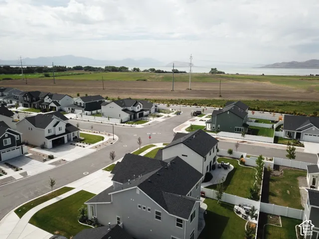 Residential development with paved streets, concrete sidewalks, and manicured lawns