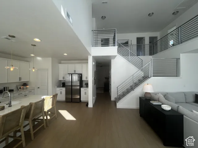 Open-concept living space with high ceilings and wood-finish flooring