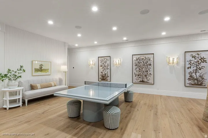 Recessed lighting illuminates the wood-finish flooring
